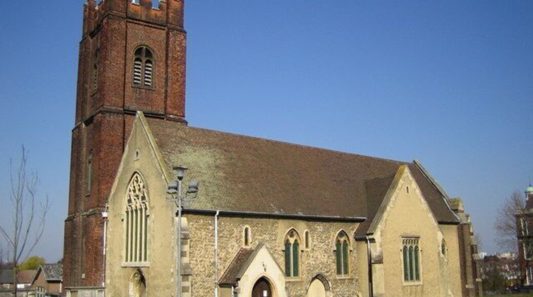 St Nicholas' parish church, Plumstead, London (formerly Kent), seen from the southwest. The oldest parts of the current building are 12th-century. The red brick tower was completed in 1664. On 11 February 1907 an explosion in a magazine in the Chemical Research Department of the Woolwich Arsenal on Plumstead Marshes caused a further explosion of a gasometer causing much damage to surrounding property in Woolwich and Plumstead, including the Church. Fortunately no lives were lost in the explosion. The Church was restored, but also suffered further extensive damage during the Second World War, requiring more restoration.