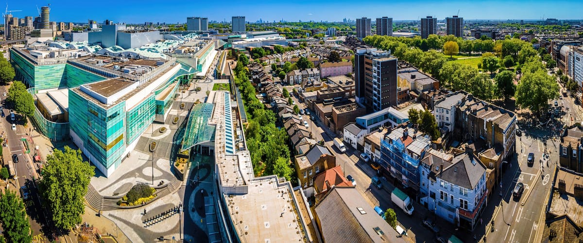 A cityscape with modern buildings, a large open plaza, and a mix of residential and commercial structures.