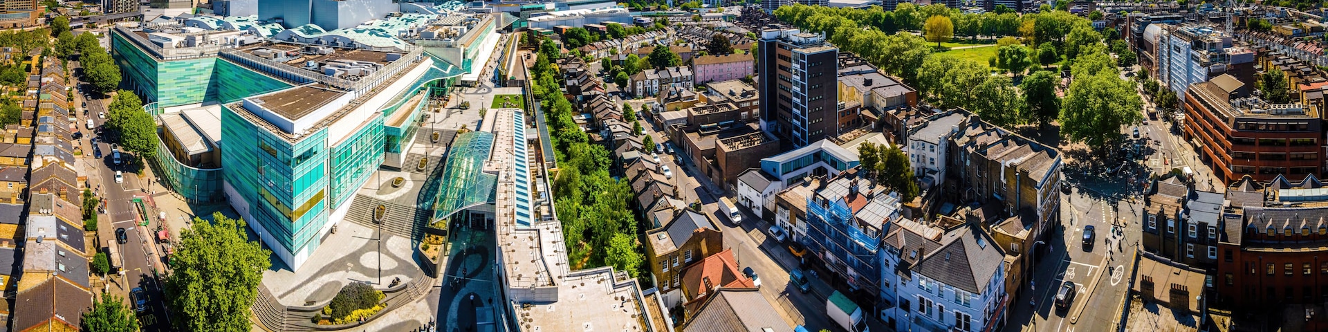 A cityscape with modern buildings, a large open plaza, and a mix of residential and commercial structures.