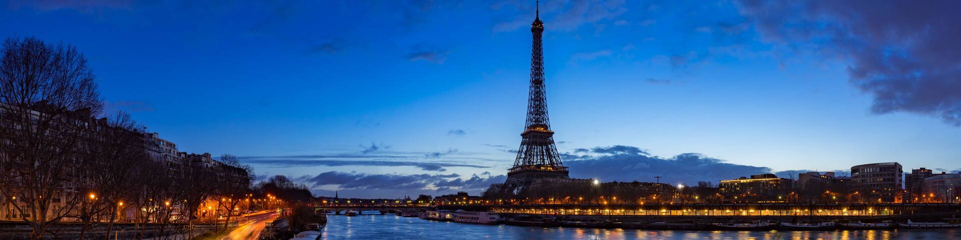 Eiffel Tower and Seine River banks in early morning light. Panoramic view in Paris, France