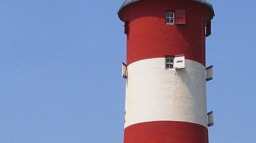 Relax-e-vous Young woman relaxing in the sun at Smeaton's tower lighthouse, Plymouth Hoe.