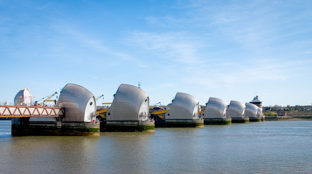A series of large, white, dome-shaped structures with a bridge in the foreground.
