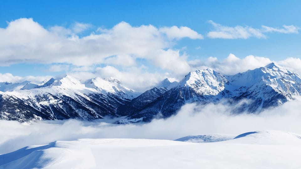 Panoramic view of mountains near Brianson, Serre Chevalier resort, France. Ski resort landscape on clear sunny day. Mountain ski resort. Snow slope. Snowy mountains. Winter vacation. Panorama, banner.