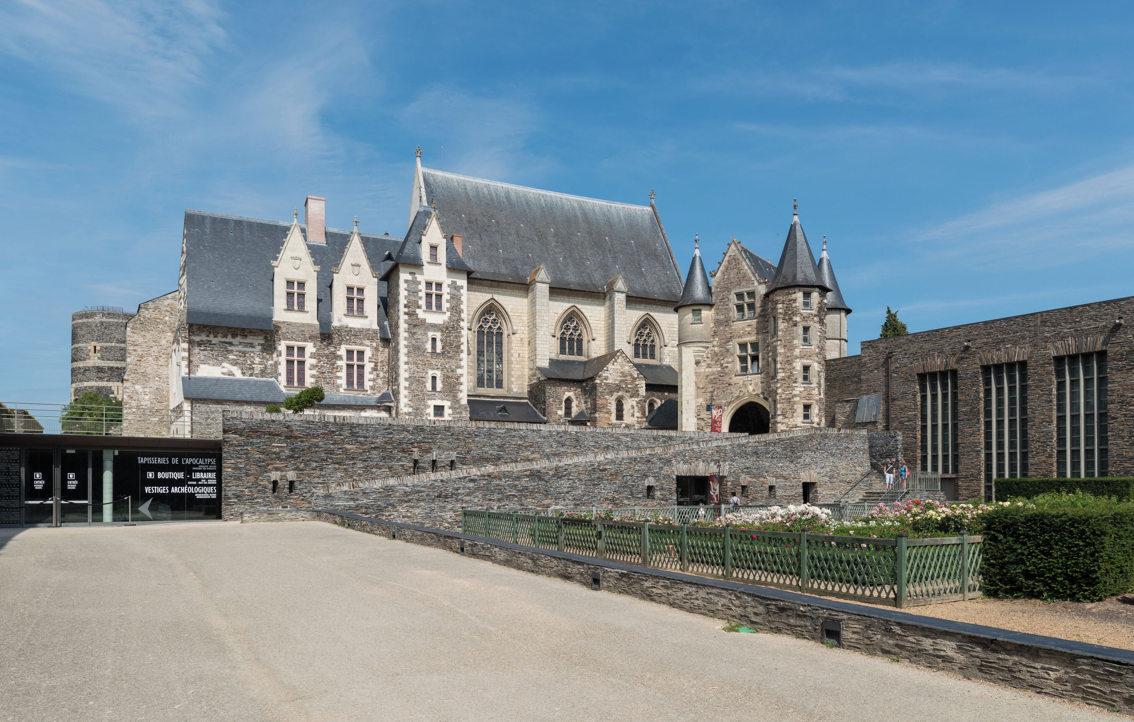 A historic stone building with multiple towers and a large staircase leading to its entrance.