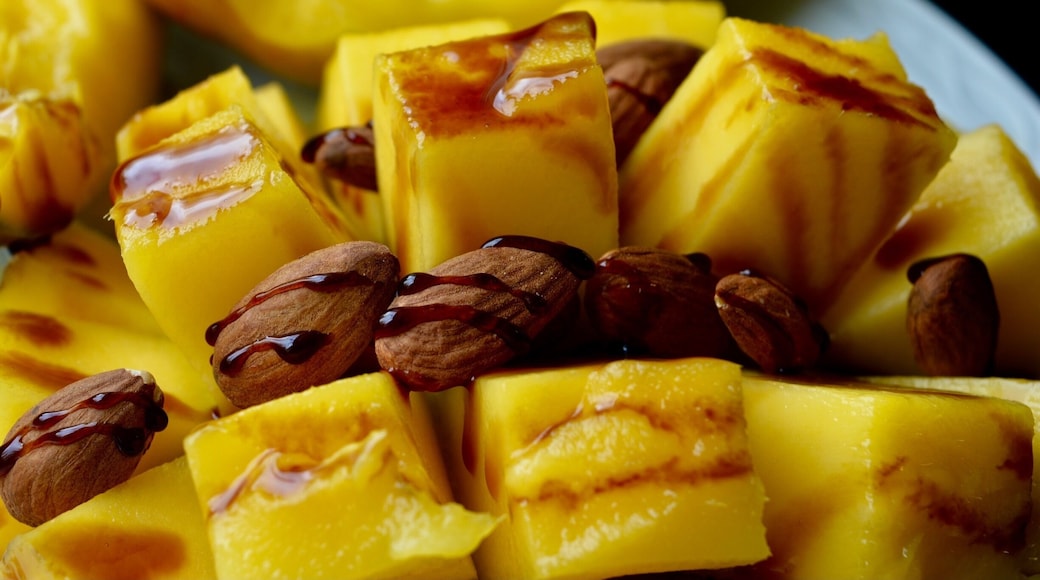 Fresh mango with almonds topped with balsamic glaze....nectar of the gods