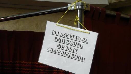Just outside the city of Wells is a place called Wookey Hole, where you can go and visit underground caves. The whole area is very rocky with a gorge (Cheddar) nearby which is amazing. There's a small village, with shops built up against the cliffs, and in a shop selling clothing I saw this. Not a problem you get in many changing rooms!