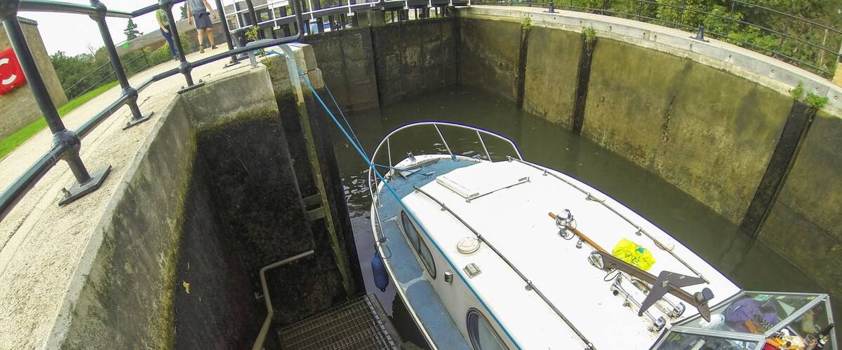 A boat being guided through a lock system.