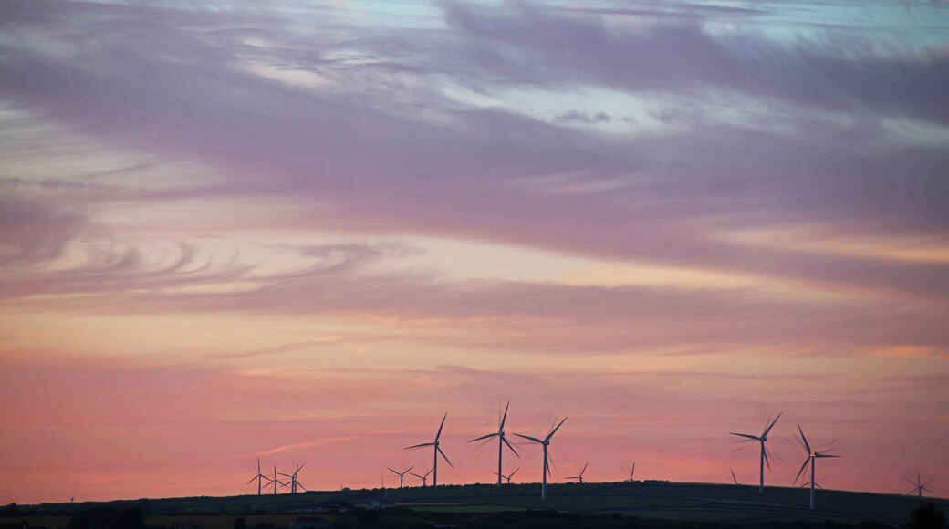 Sunset over the wind farm across the countryside of Quintrell Downs near Newquay in Cornwall.