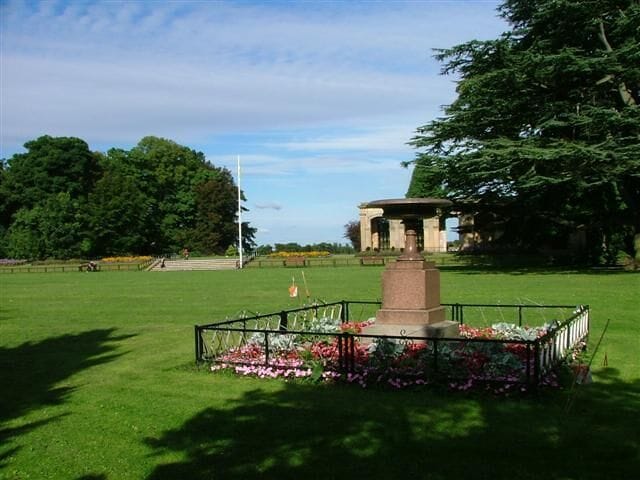 Granite Urn, Stewart Park. This granite urn was erected by Henry Bolckow, the wealthiest and most powerful local ironmaster, to mark the spot where Capt. James Cook was born in the old village of Marton. Henry Bolckow had decided to build his new house on this site and promptly relocated the villagers into new houses built on Marton Road 500m to the south west 55056. The Bolckows moved into their new mansion, Marton Hall, in 1858. In 1878 the estate passed to Bolckow's nephew Carl who managed to continue to lead an extravagant lifestyle despite the boom years of the iron industry being over. By 1907 the hall was empty, all fixtures being sold to pay off his debts. Apart from the billeting of troops during WW1 it was never lived in again. The estate was brought in 1925 by Thomas J Stewart who presented it to Middlesbrough as a park. In 1960 a fire broke out and the hall was reduced to ashes. The steps and stonework in the photo are all that remains.