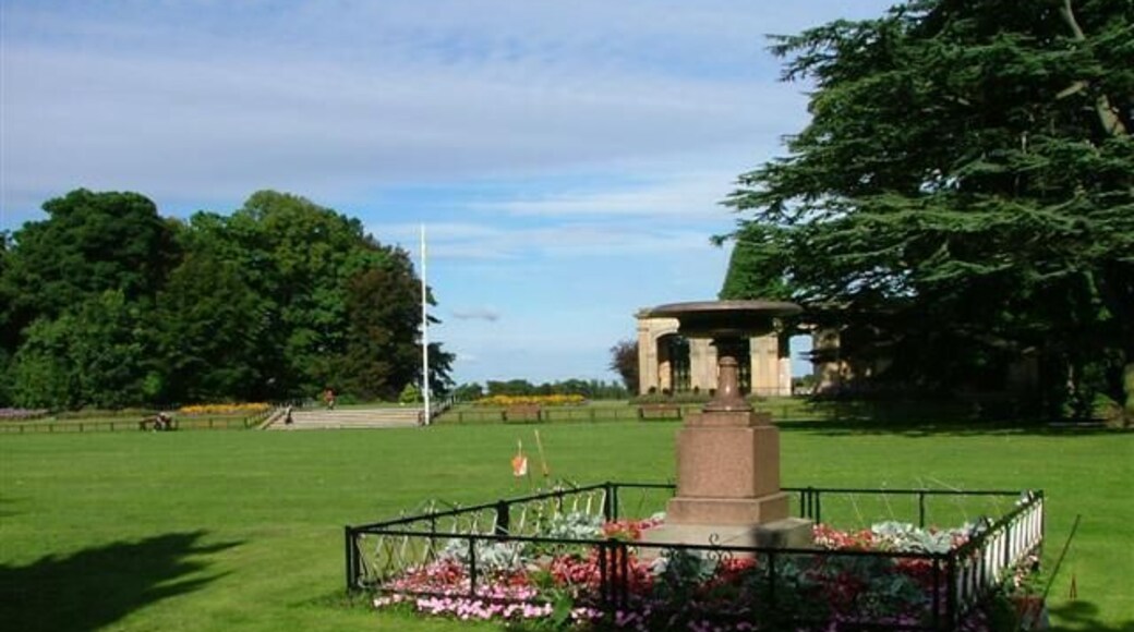 Granite Urn, Stewart Park. This granite urn was erected by Henry Bolckow, the wealthiest and most powerful local ironmaster, to mark the spot where Capt. James Cook was born in the old village of Marton. Henry Bolckow had decided to build his new house on this site and promptly relocated the villagers into new houses built on Marton Road 500m to the south west 55056. The Bolckows moved into their new mansion, Marton Hall, in 1858. In 1878 the estate passed to Bolckow's nephew Carl who managed to continue to lead an extravagant lifestyle despite the boom years of the iron industry being over. By 1907 the hall was empty, all fixtures being sold to pay off his debts. Apart from the billeting of troops during WW1 it was never lived in again. The estate was brought in 1925 by Thomas J Stewart who presented it to Middlesbrough as a park. In 1960 a fire broke out and the hall was reduced to ashes. The steps and stonework in the photo are all that remains.