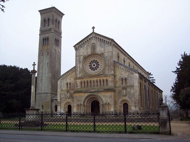 A large historic church with a prominent clock tower and a tall bell tower.