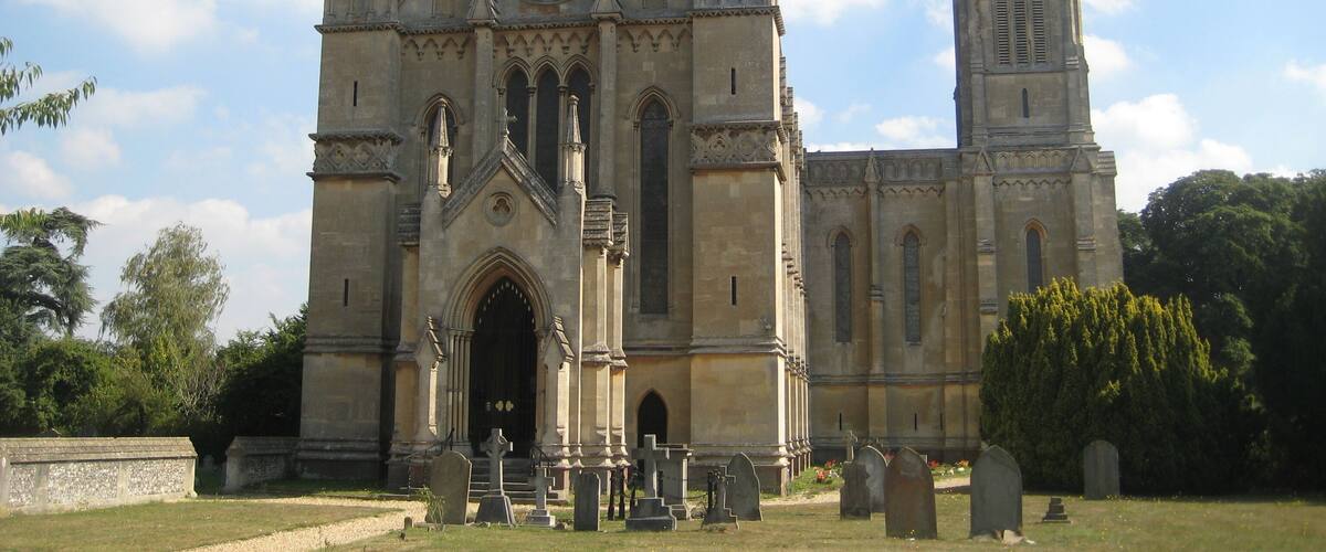 A large Gothic-style church with a prominent rose window and twin spires.