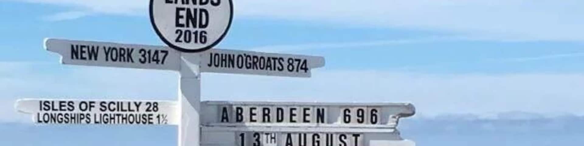 A signpost with directions to various locations including New York, John OGroats, and Aberdeen.
