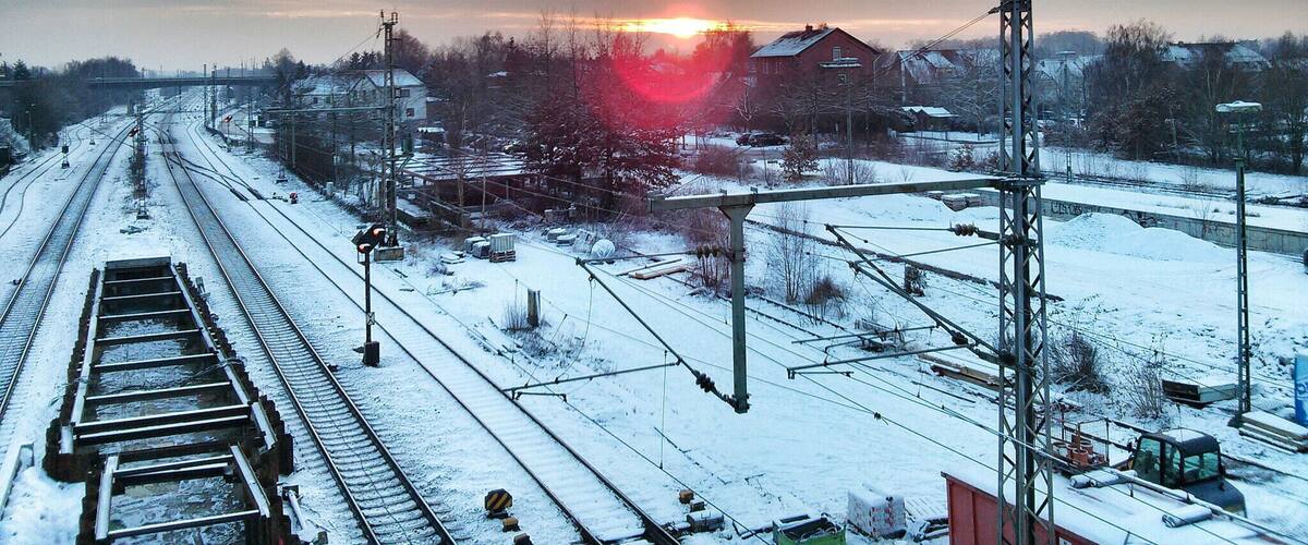 A railway track with a sunset in the background.