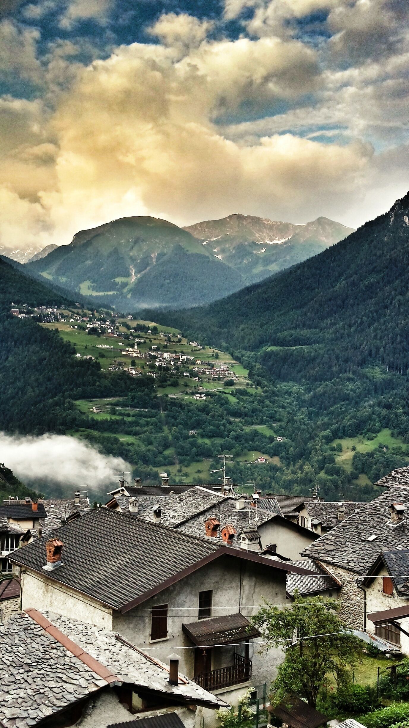 A mountainous landscape with a village nestled in the valley.