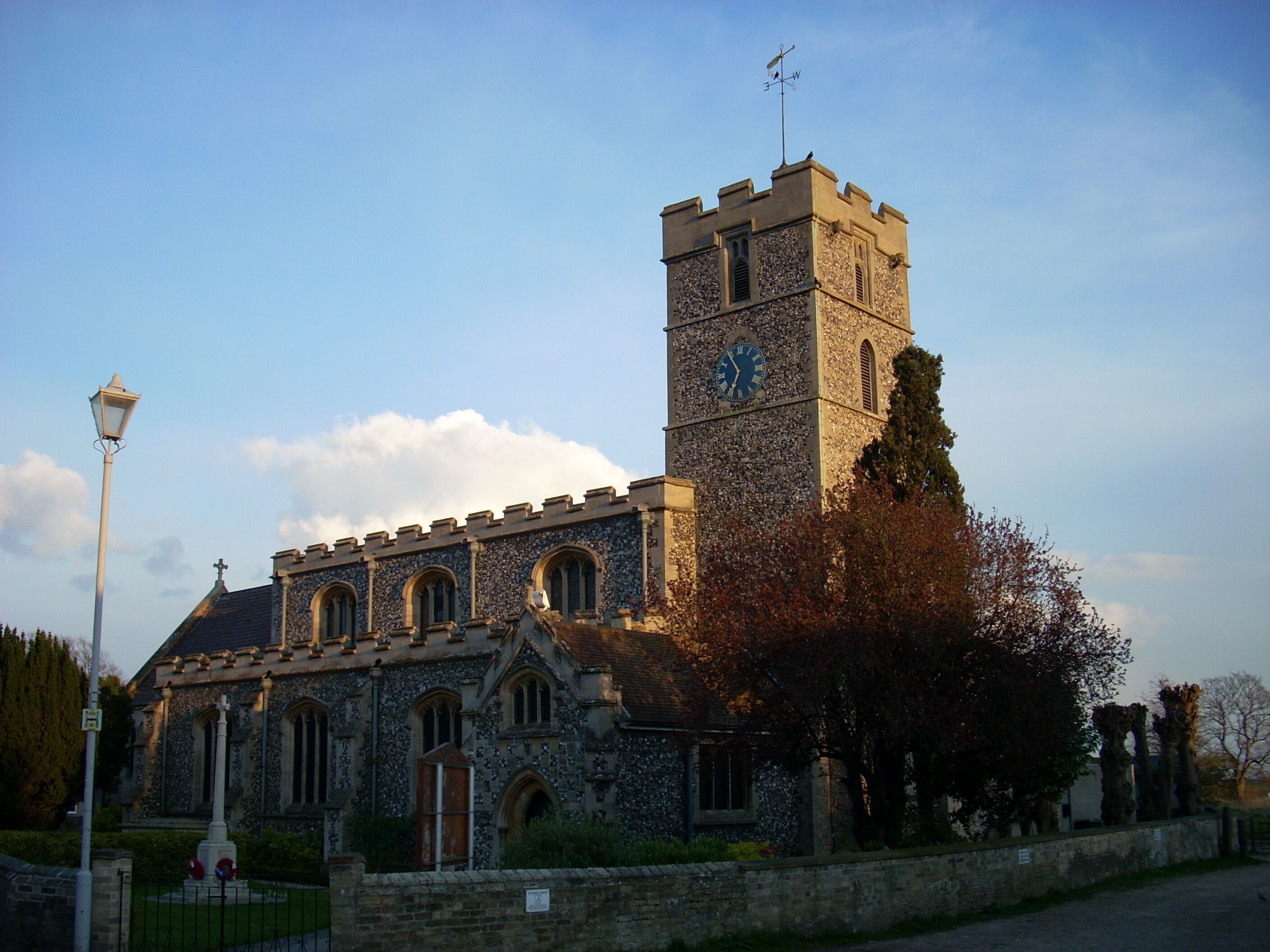 A historic church with a tall clock tower and a stone facade.
