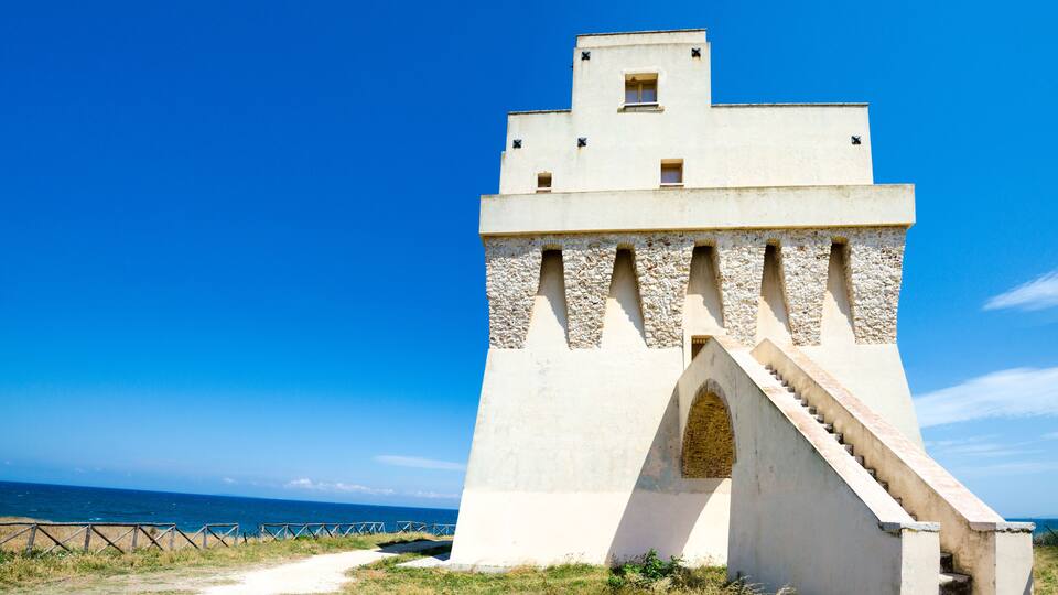 A coastal tower with a staircase and a clear view of the sea.