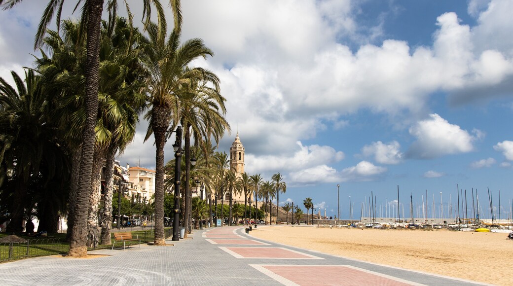 Empty promenade Passeig de la Ribera with the views of church Sant Bartomeu y Santa Tecla, Sitges, Catalonia, Spain