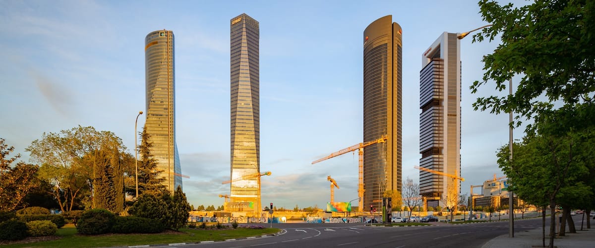 Four Towers Business Area featuring a skyscraper, a park and a sunset