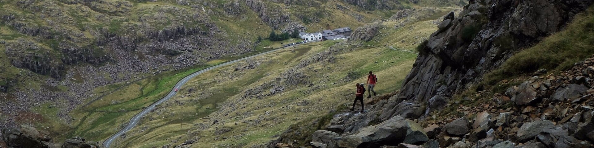 A mountainous landscape with rocky terrain and a winding road.