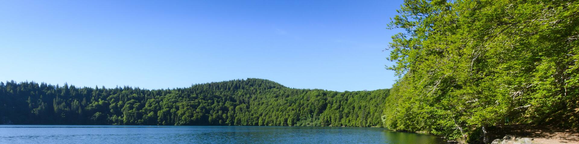 Lake Pavin in Auvergne with small boats and blue sky, Shutterstock ID 671260273, Purchase Order: -