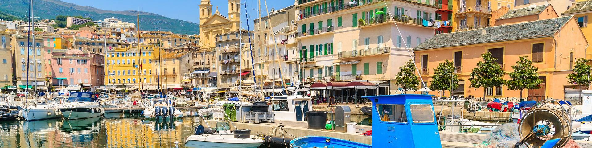 Traditional fishing boats in Bastia port on sunny summer day, Corsica island, France