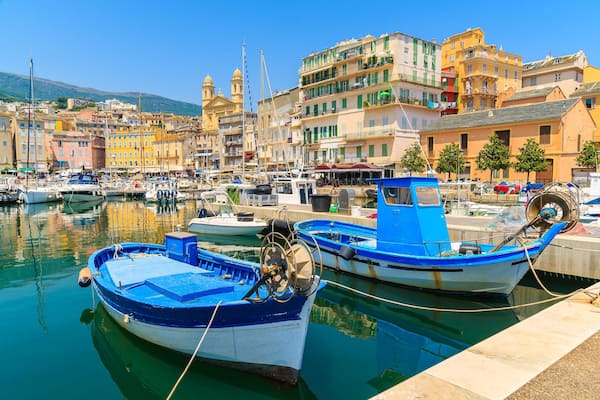 Traditional fishing boats in Bastia port on sunny summer day, Corsica island, France
