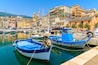 Traditional fishing boats in Bastia port on sunny summer day, Corsica island, France