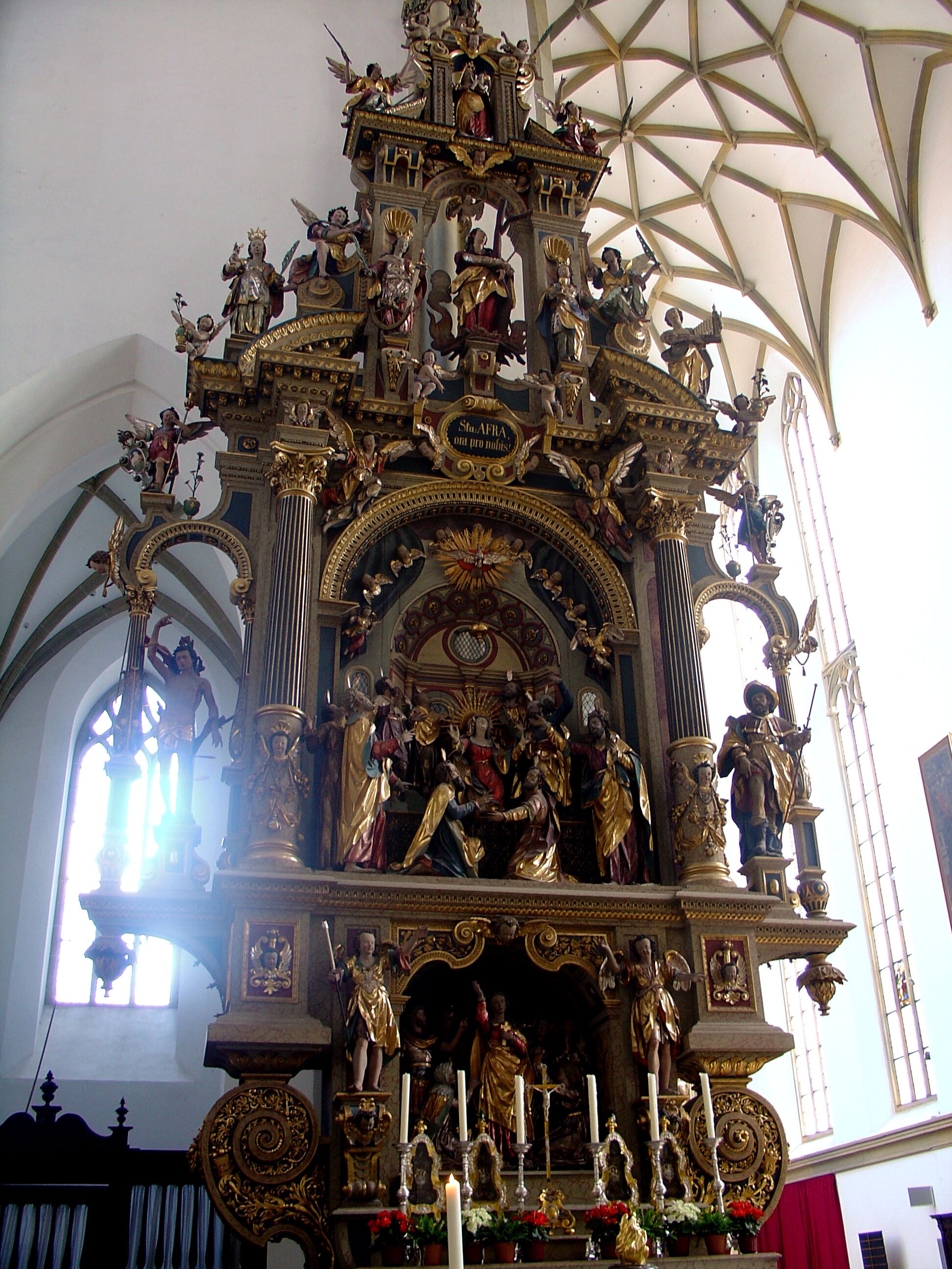 An ornate religious altar with statues and candles.