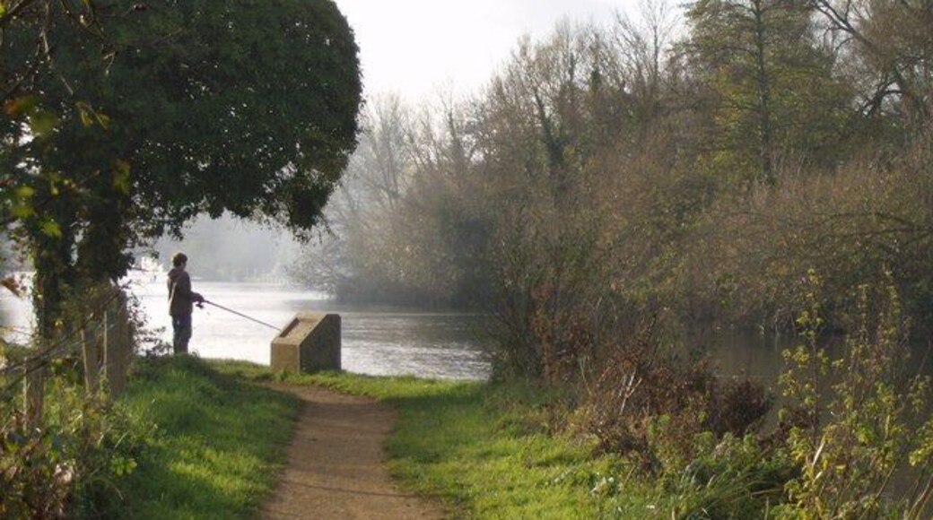 Lone fisherman On a surprisingly remote spot of the Thames path, just a mile from Reading town centre, a lone fisherman tries his luck - with little luck. The concrete plinth once carried an information board. To the right is St. Mary's Island.