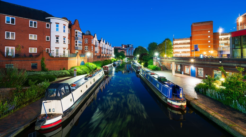 A canal with boats, buildings, and greenery.