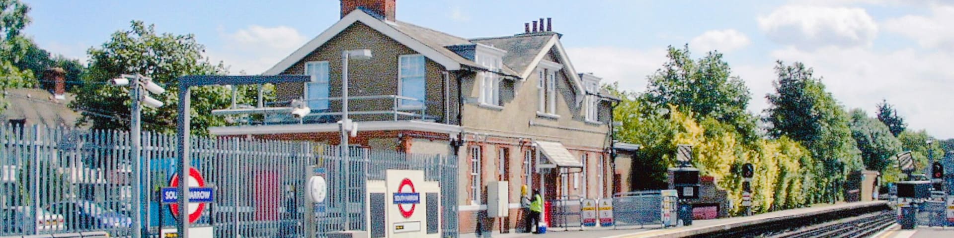 South Harrow station, Piccadilly Line. View southward on the line from Uxbridge and Rayners Lane, towards Acton Town, Piccadilly Circus, King's Cross St Pancras and Cockfosters: London Underground. The Station House is privately occupied