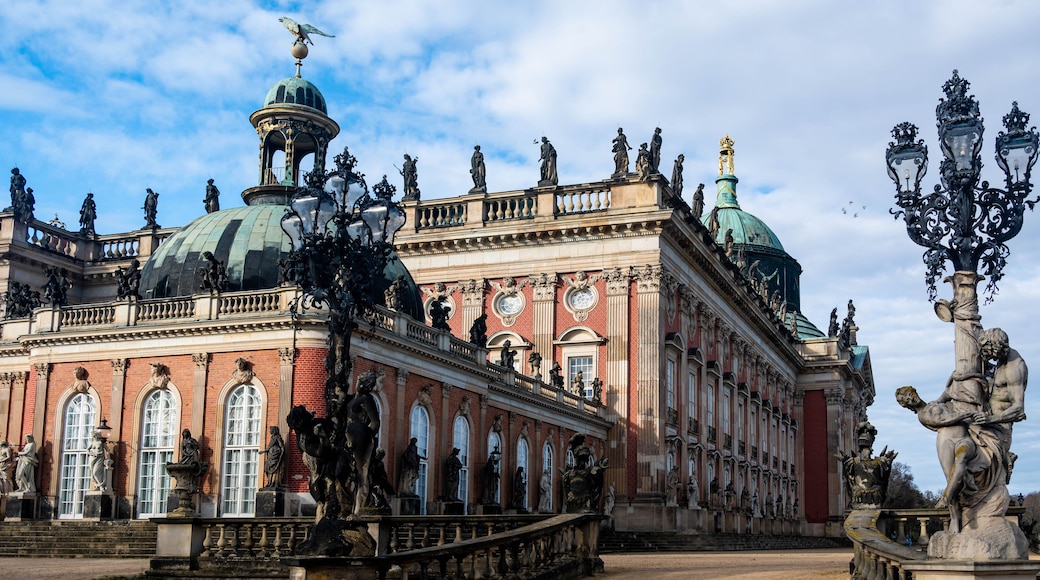 A grand historical building with ornate sculptures, domed roofs, and classical architecture.