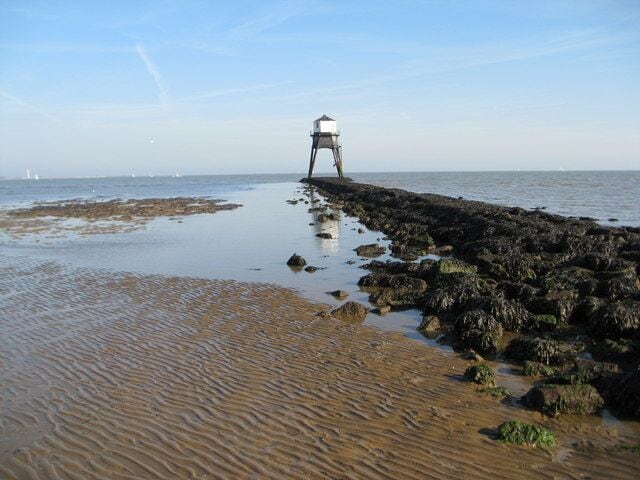 Reflections of Low Level Lighthouse at Dovercourt The causeway is creating a patch of still water in which the lighthouse is reflecting.