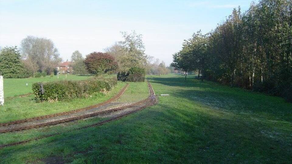 Eastcote: Miniature railway, Roxbourne Park. Viewed looking north eastwards, with Yeading Brook off beyond the trees to the right, the miniature railway is run by the Harrow and Wembley Society of Model Engineers. http://www.hwsme.org.uk/index.htm gives copious details about the history, rolling stock, running times, etc. of the railway.