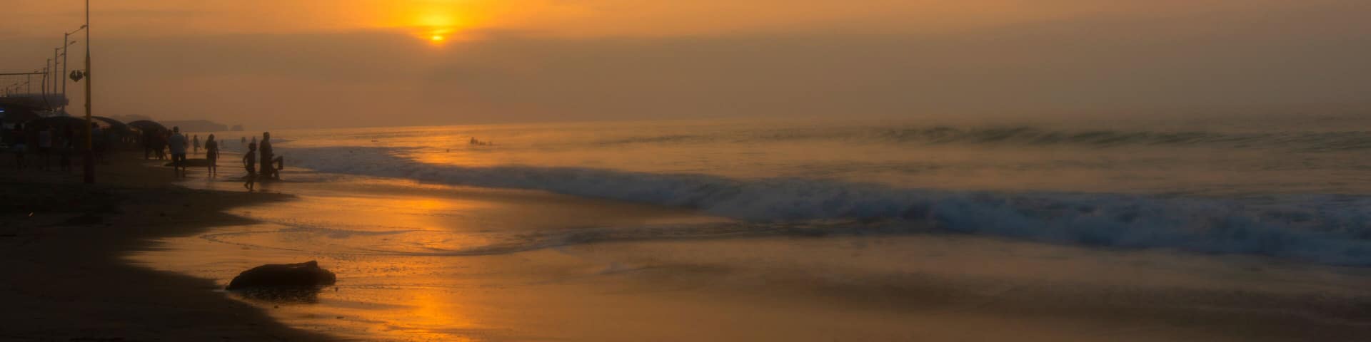 People walking on the beach of Tonsupa at sunset