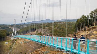 Mishima Sky Walk featuring a bridge and landscape views as well as a small group of people
