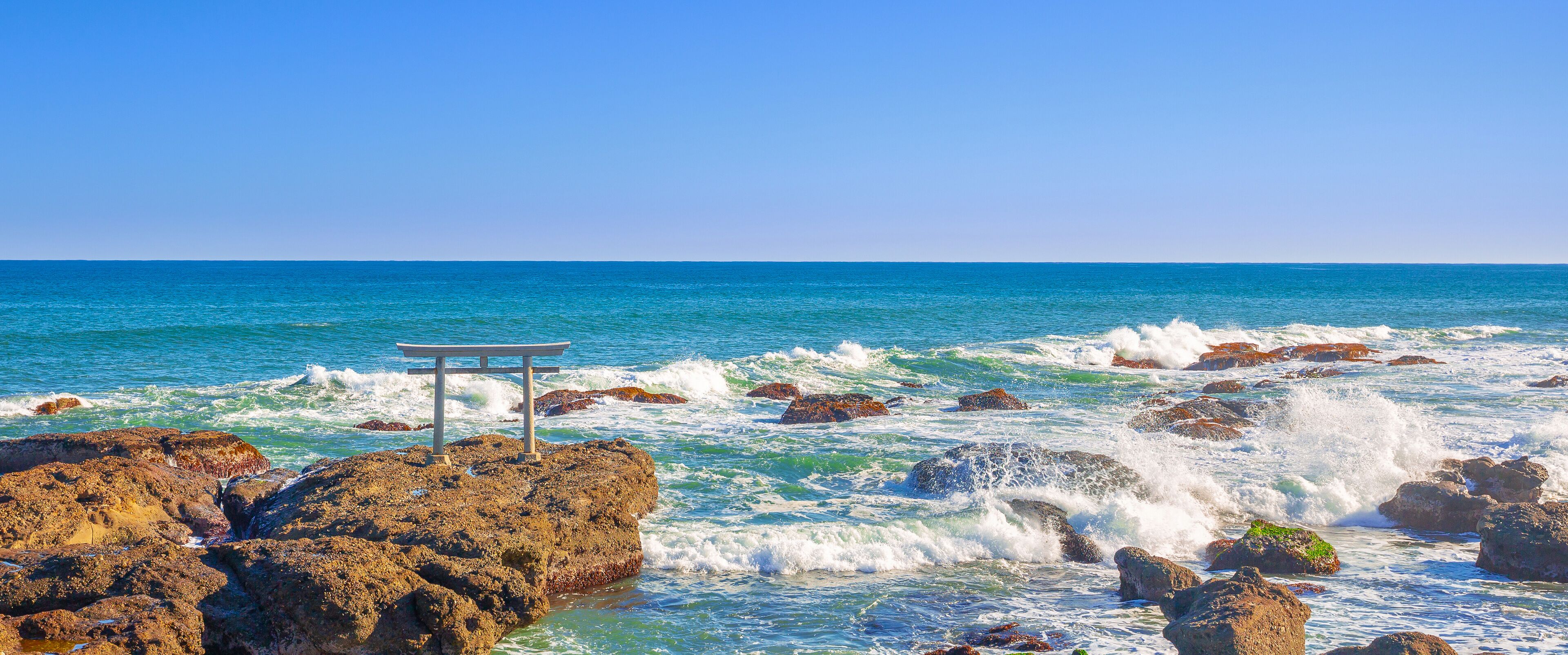 Panorama view one of the tourist attraction in Japan, Torii gates of Oarai Isosaki-jinja by the sea in bright blue sky day