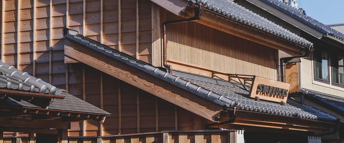 A traditional Japanese building with wooden slats and a tiled roof.