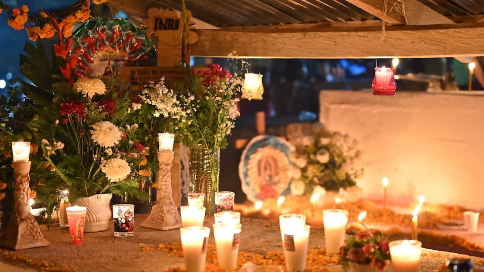 A shrine with candles, flowers, and religious icons.