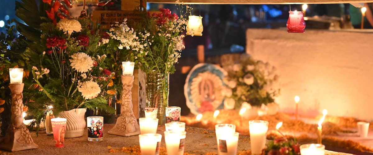 A shrine with candles, flowers, and religious icons.