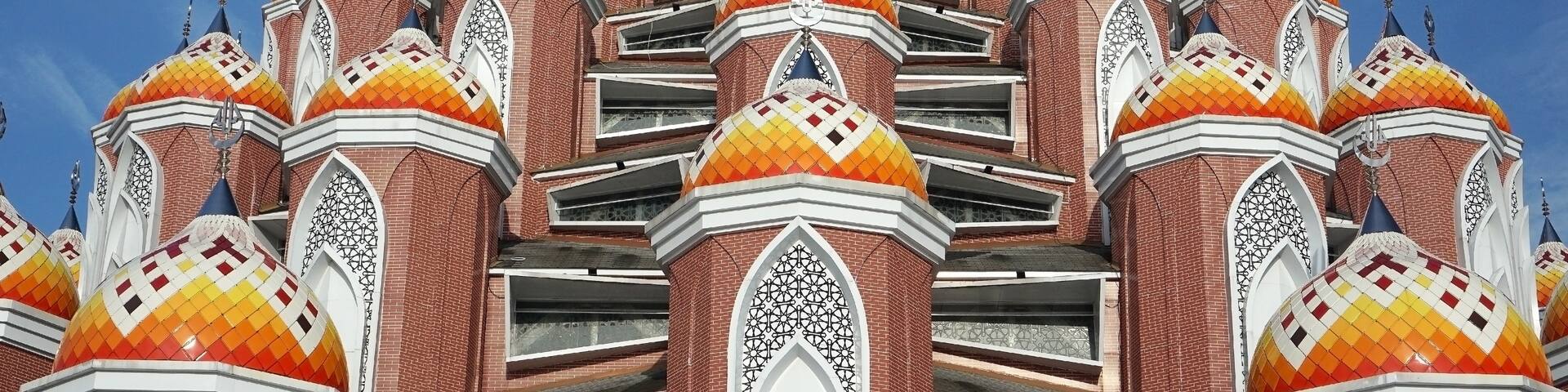 A multi-domed building with intricate patterns and a clear blue sky.