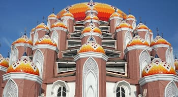A multi-domed building with intricate patterns and a clear blue sky.