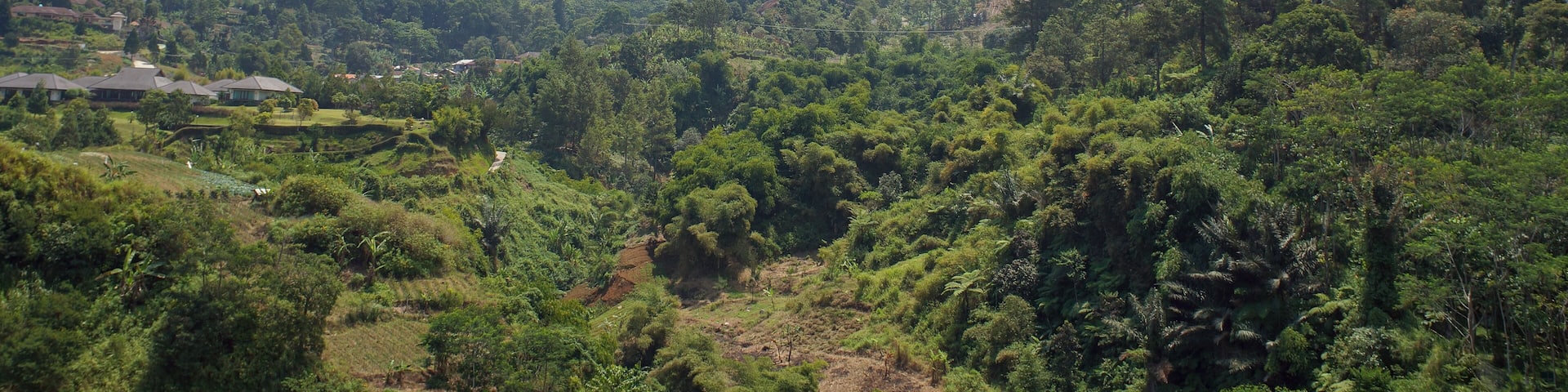 View of stratovolcano in Indonesia, Mount (gunung) Gede Pangrango with clouds in blue sky background. Located in Cisarua - Bogor Regency and Cipendawa, Pacet - Cianjur Regency, West Java, Indonesia.