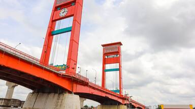 The red Ampera Bridge in Palembang City, South Sumatra, over the Musi River