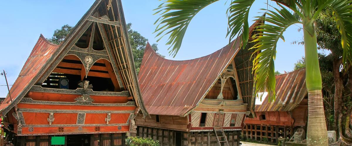 Traditional wooden houses with steep roofs and decorative elements.