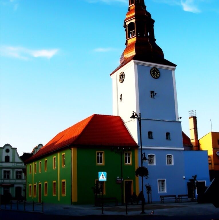 A church with a clock tower and a red roof.