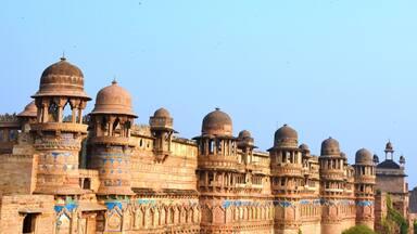 A historic fort with multiple domes and intricate carvings.