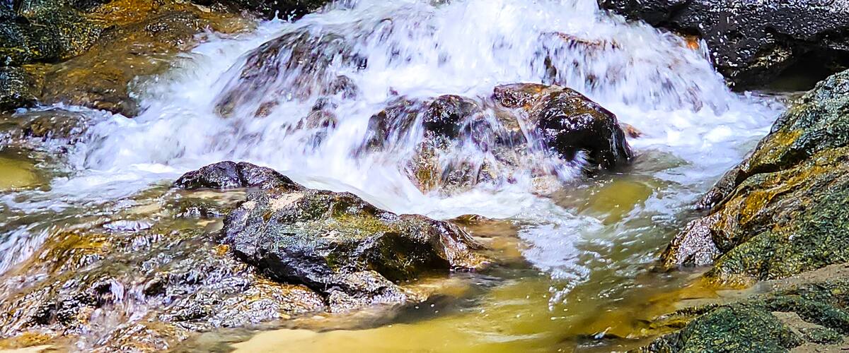 A rocky stream with flowing water.
