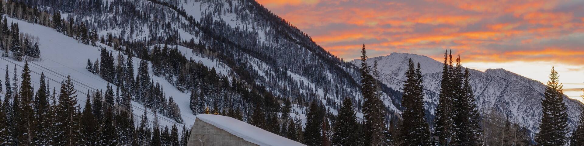 Spectacular sunset view of golden clouds over mountains in winter from Snowbird in Little Cottonwood Canyon in the Wasatch Range near Salt Lake City, Utah, USA.